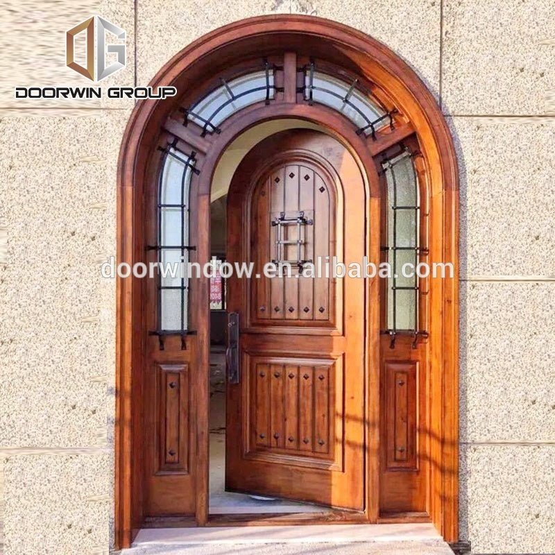 Arched top iron clavos door design with Q-Lon weather strip insulation and solid wood front door frame by Doorwin - Doorwin Group Windows & Doors